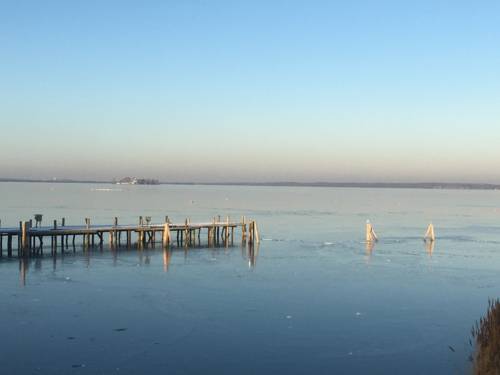 Steg im Winter im Steinhuder Meer, Teile des Stegs sind abgebaut. Im Hintergrund ist die Insel Wilhelmstein zu sehen.