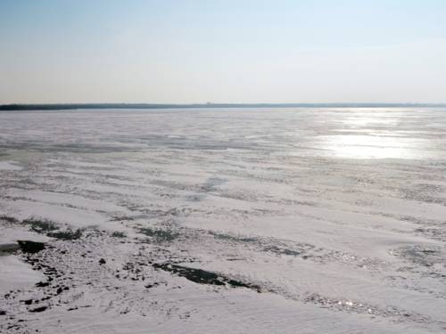 Eine verschneite Eisschicht liegt auf dem Steinhuder Meer.