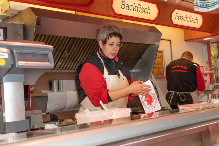 Eine Verkäuferin in einem Fischwagen.