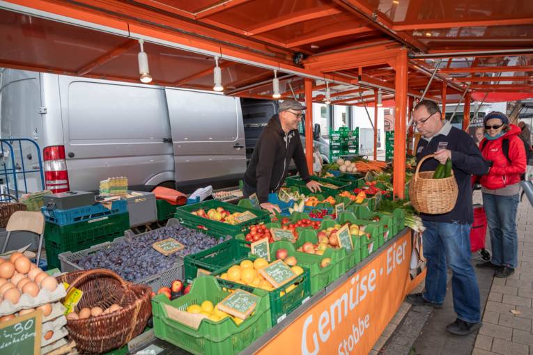 Gute Laune bei Händlern und Kundschaft am Obst- und Gemüsewagen.